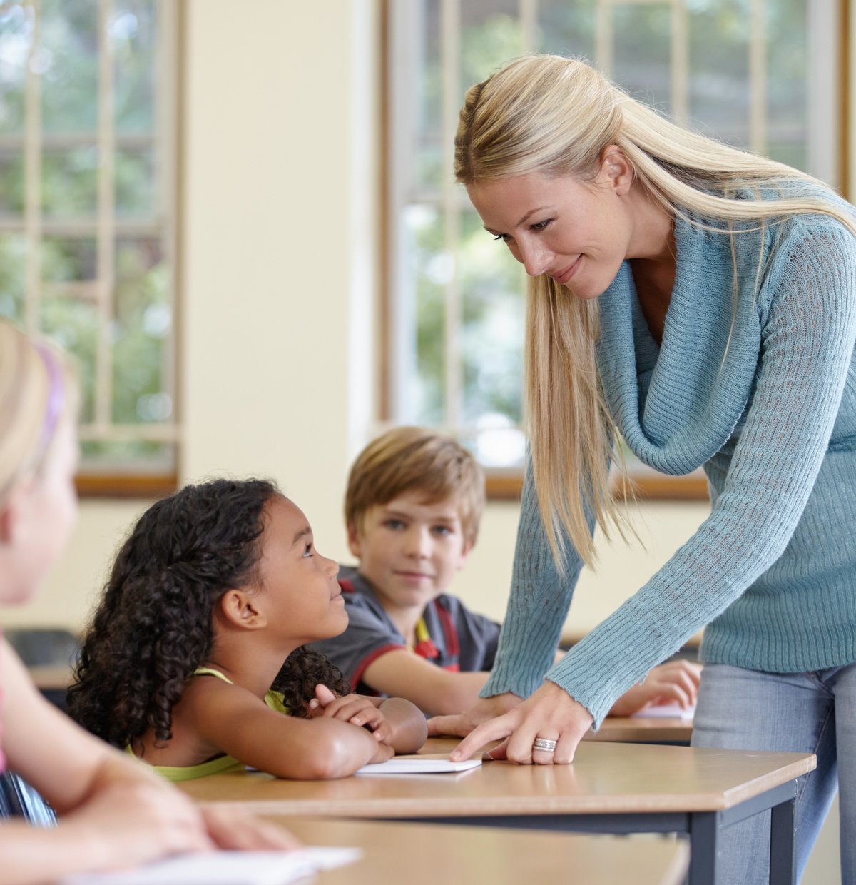 a teacher helps a student with their work