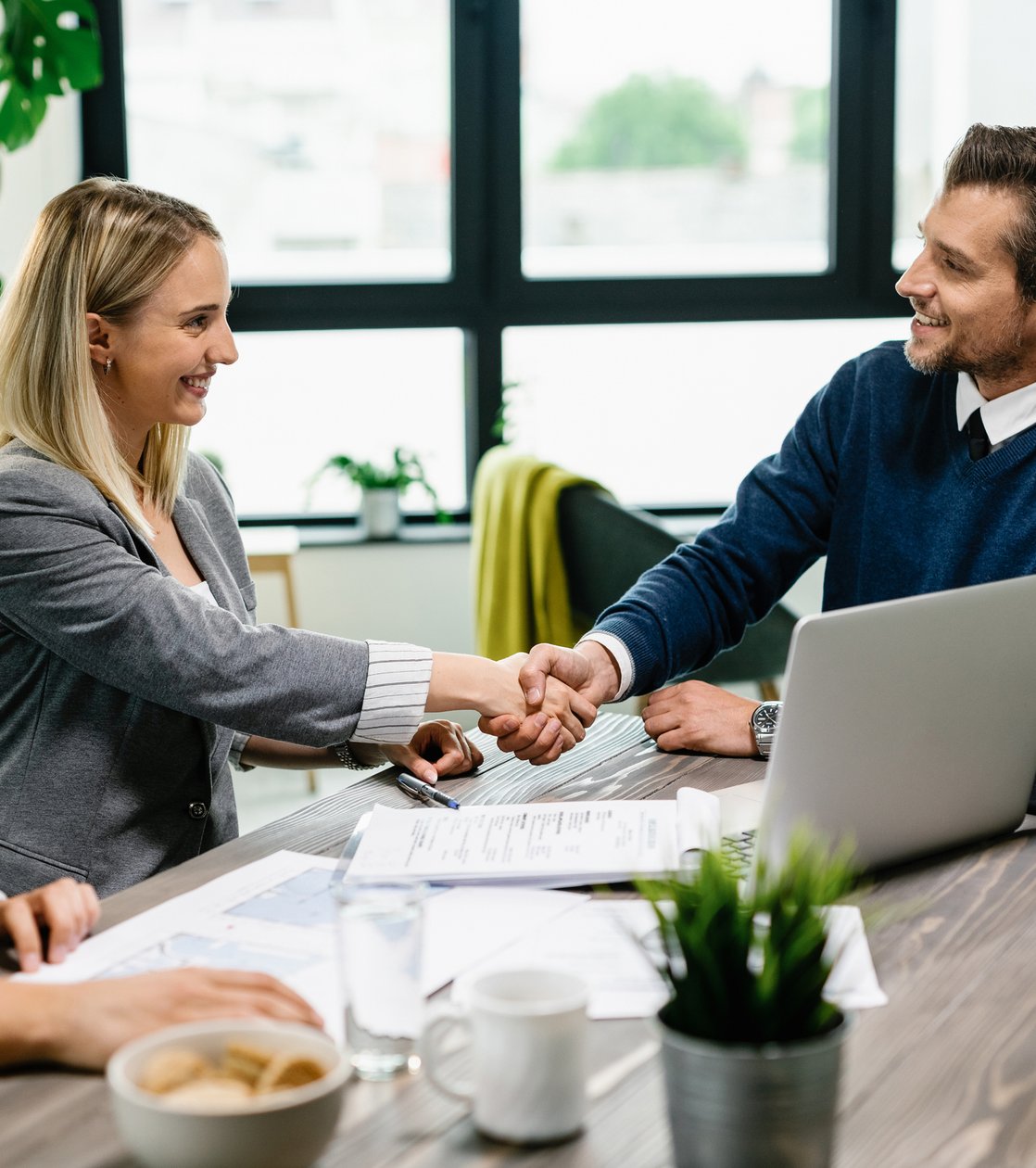 a recruiter and a teacher shaking hands