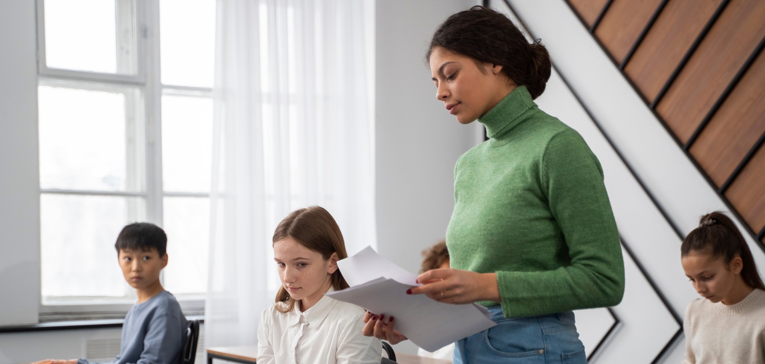 A teacher giving out test scores to students