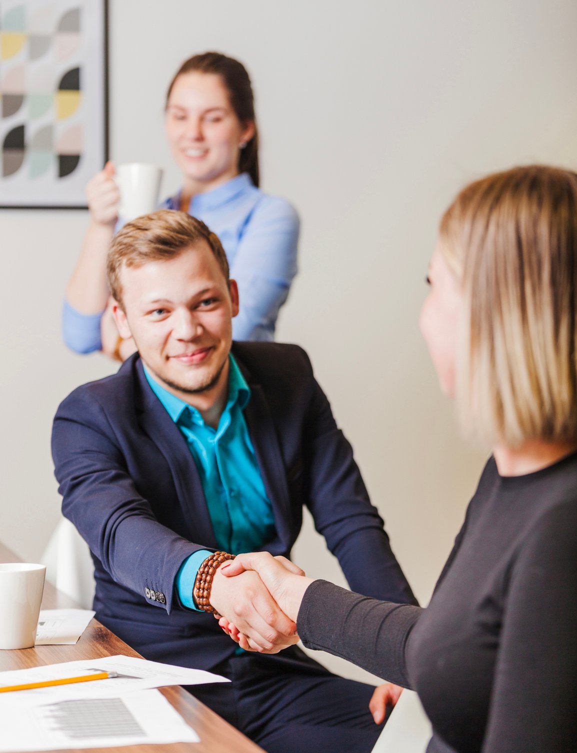 A teaecher and a recruiter shake hands